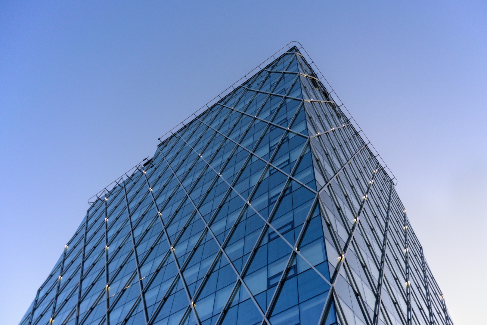 Looking up the glass facade of a modern office tower